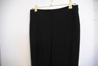 black The Row stretch knit pants, Waist (flat, unstretched): 13 in Rise: 11 in Inseam: 30 in Hip: 17 in Leg Opening: 7 in Fit: Slim leg, tapered Material: Midweight stretch knit (likely viscose-blend)