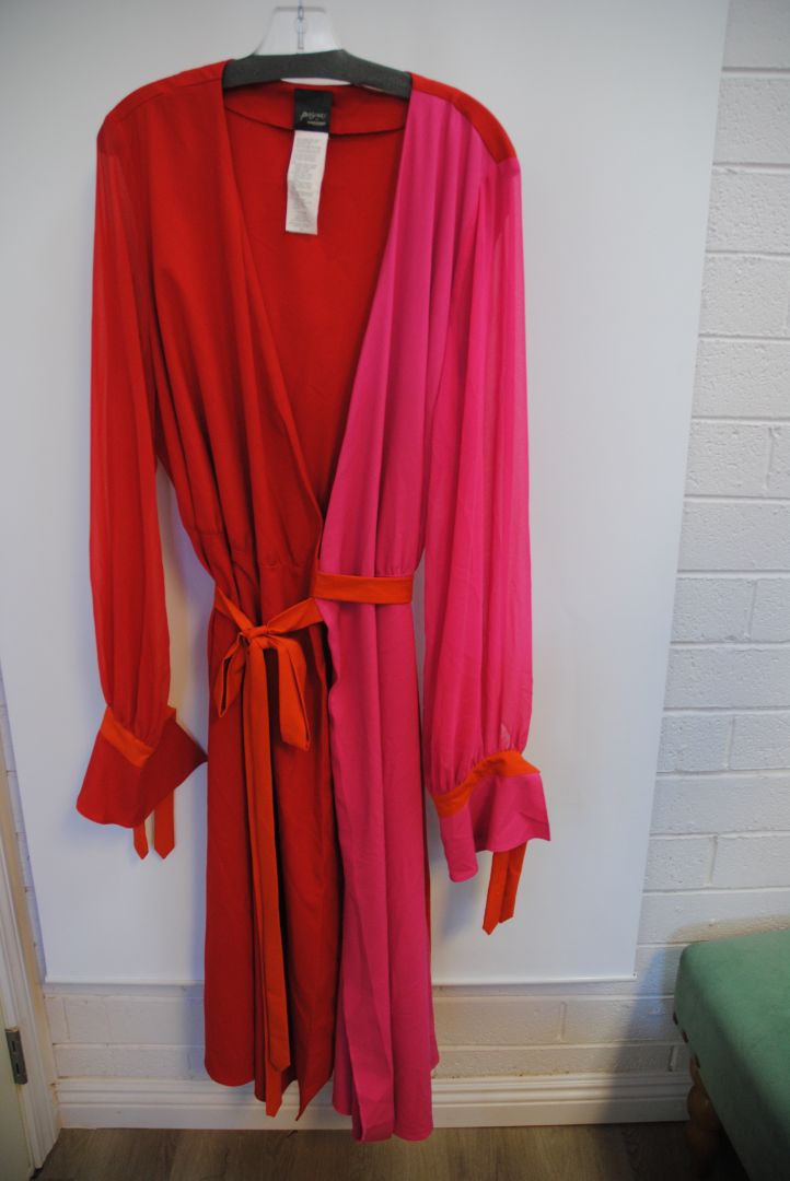 pink and red Marina Rinaldi Persona designer dress, Bust: 22.5 in (flat) Waist (adjustable tie): up to 21 in Hip: 24 in Length: 50 in (shoulder to hem) Sleeve Length: 24.5 in Fit: Relaxed wrap fit with tie belt