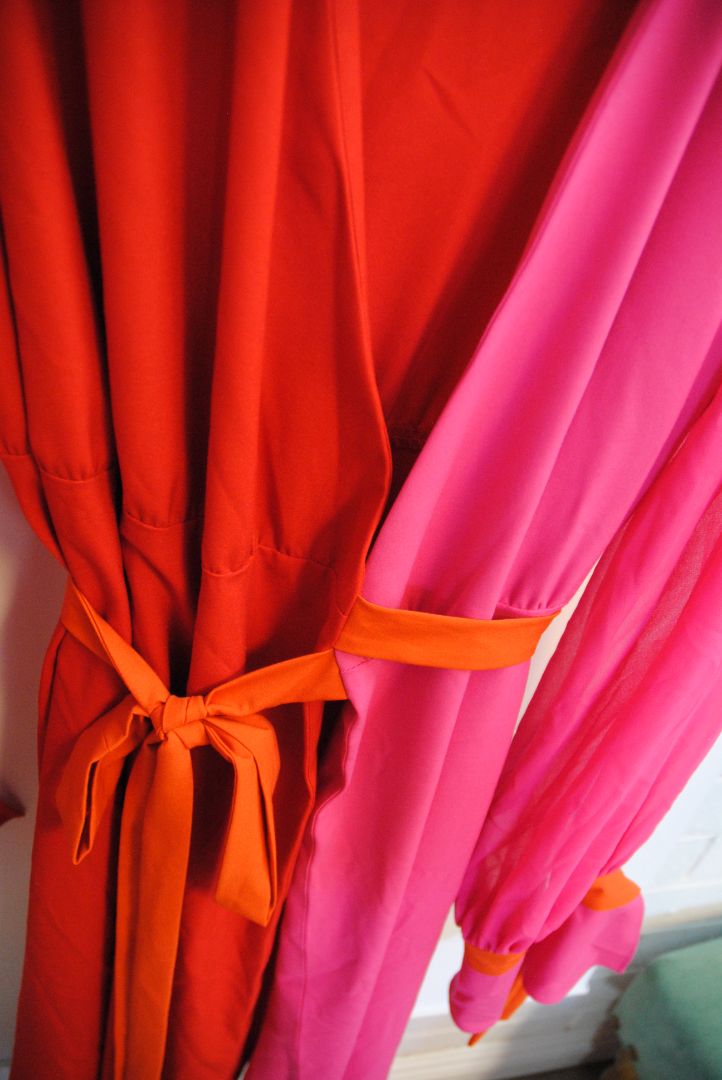 pink and red Marina Rinaldi Persona designer dress, Bust: 22.5 in (flat) Waist (adjustable tie): up to 21 in Hip: 24 in Length: 50 in (shoulder to hem) Sleeve Length: 24.5 in Fit: Relaxed wrap fit with tie belt