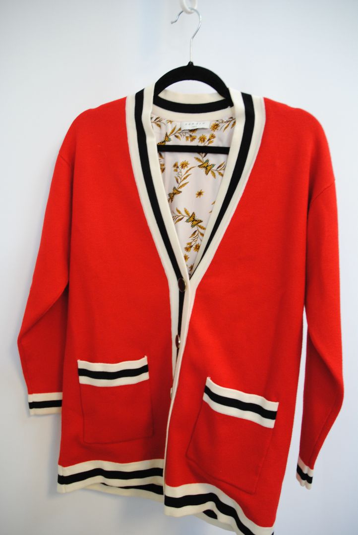 red Sandro knit cardigan, Bust (flat): 19.5 in Length (shoulder to hem): 27 in Sleeve Length: 21.5 in Shoulder to Shoulder: 17 in Fit: Relaxed, hip-length silhouette Closure: Button-down front