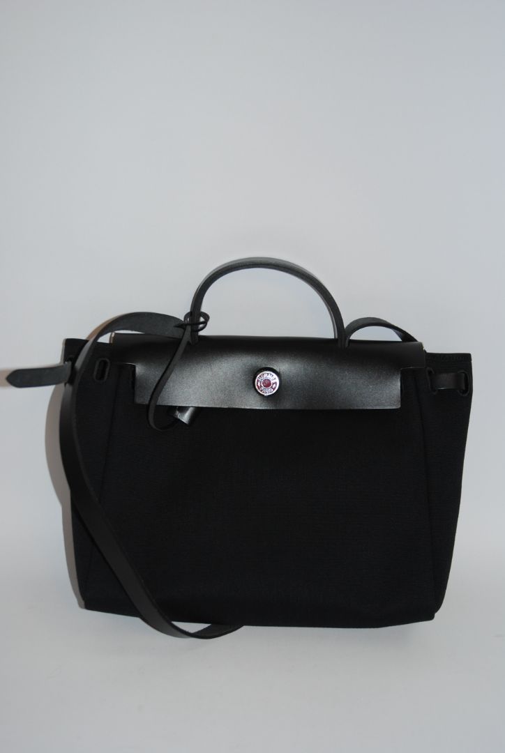 Black Canvas & Vache Hunter Leather with Palladium Hardware Hermes Hermès Herbag Zip 31 Retourne, Length: 12.25 in (31 cm) Height: 10 in (25 cm) Depth: 4.25 in (11 cm) Handle Drop: 2 in Strap Drop: Adjustable, up to 18 in (crossbody or shoulder)