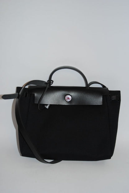 Black Canvas & Vache Hunter Leather with Palladium Hardware Hermes Hermès Herbag Zip 31 Retourne, Length: 12.25 in (31 cm) Height: 10 in (25 cm) Depth: 4.25 in (11 cm) Handle Drop: 2 in Strap Drop: Adjustable, up to 18 in (crossbody or shoulder)