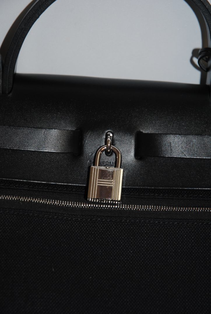 Black Canvas & Vache Hunter Leather with Palladium Hardware Hermes Hermès Herbag Zip 31 Retourne, Length: 12.25 in (31 cm) Height: 10 in (25 cm) Depth: 4.25 in (11 cm) Handle Drop: 2 in Strap Drop: Adjustable, up to 18 in (crossbody or shoulder)