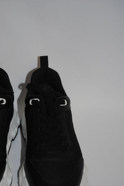 black and white Hermès Bouncing Sneaker, Heel Height: 1.5 in Platform: 1.25 in Fit: True to size (standard men’s sizing; this appears to be ~EU 41–43) Weight: Lightweight EVA sole (typical of Bouncing/Trail line)