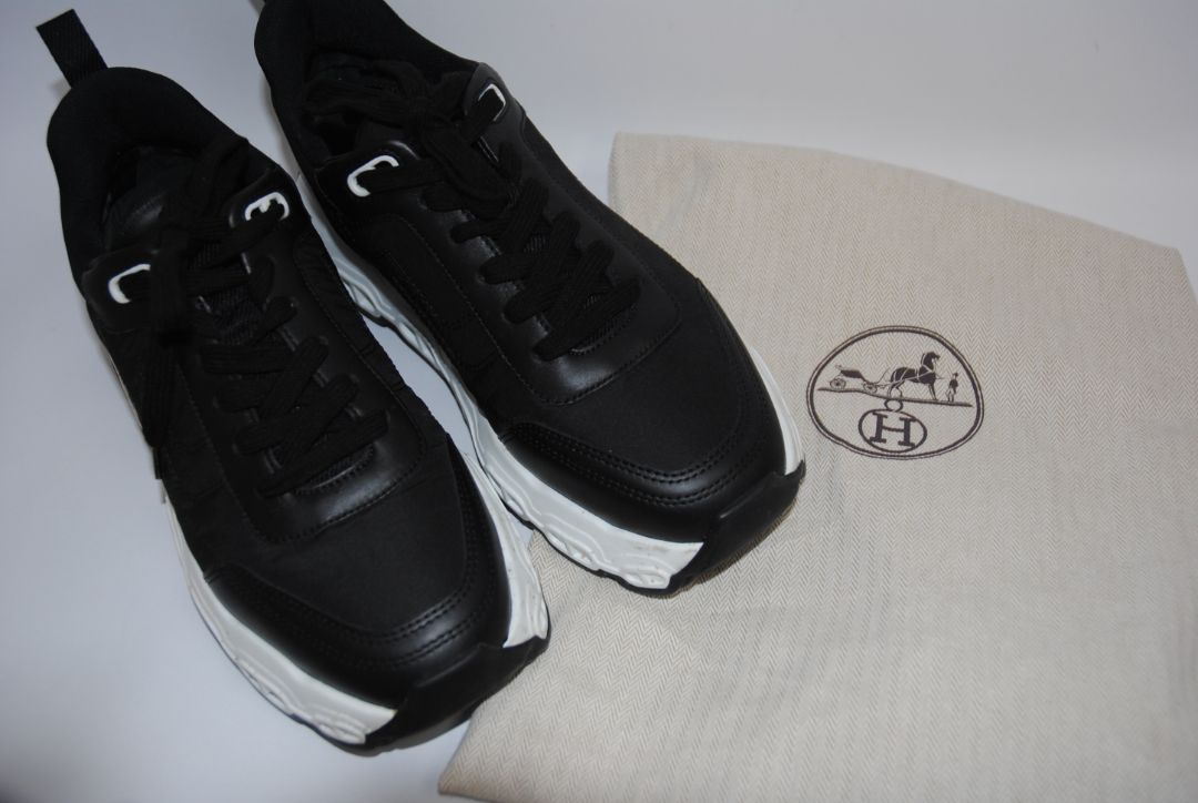 black and white Hermès Bouncing Sneaker, Heel Height: 1.5 in Platform: 1.25 in Fit: True to size (standard men’s sizing; this appears to be ~EU 41–43) Weight: Lightweight EVA sole (typical of Bouncing/Trail line)