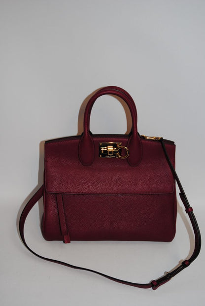 deep raspberry Salvatore Ferragamo Gancini top handle cross body, Length: 10.5 in Height: 8.25 in Depth: 5 in Top Handle Drop: 4 in Strap Drop: Adjustable, approx. 18–22 in