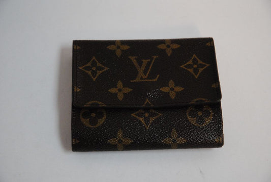monogram Louis Vuitton canvas wallet, Approx. 4.3” W x 3.5” H x 1” D Compact bi-fold silhouette