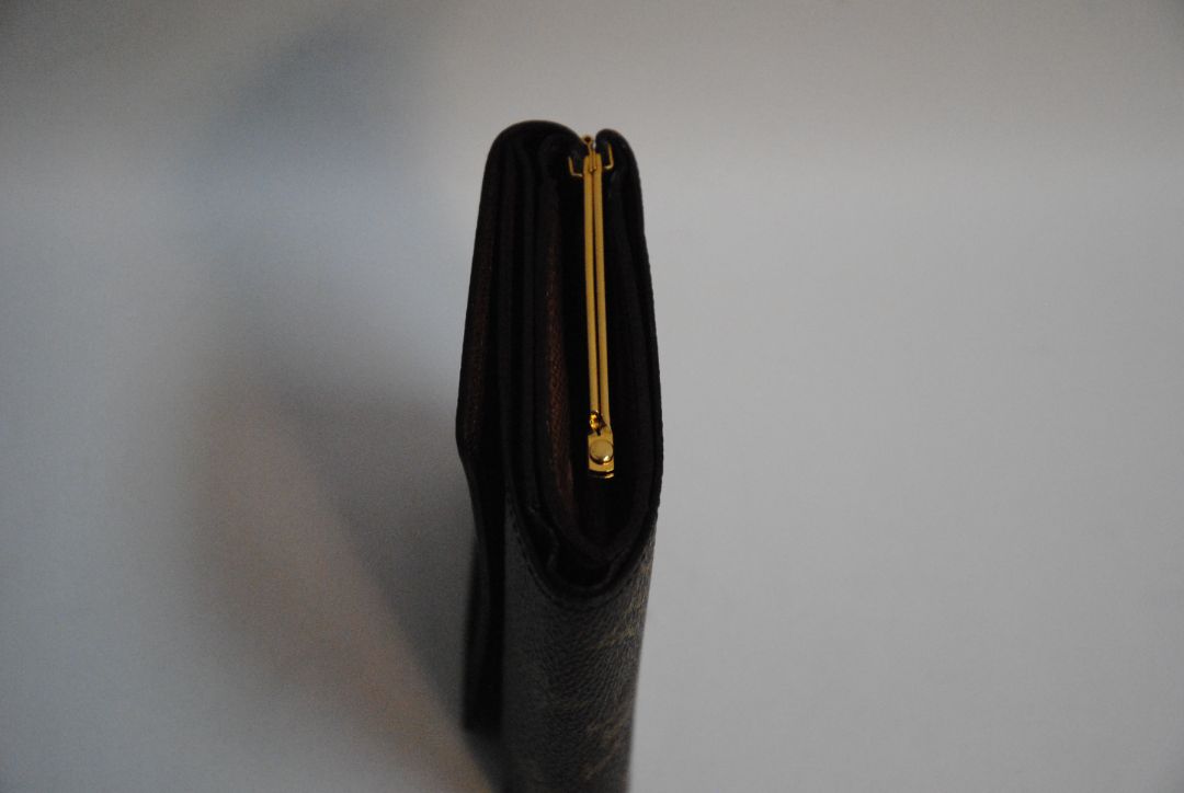 monogram Louis Vuitton canvas wallet, Approx. 4.3” W x 3.5” H x 1” D Compact bi-fold silhouette