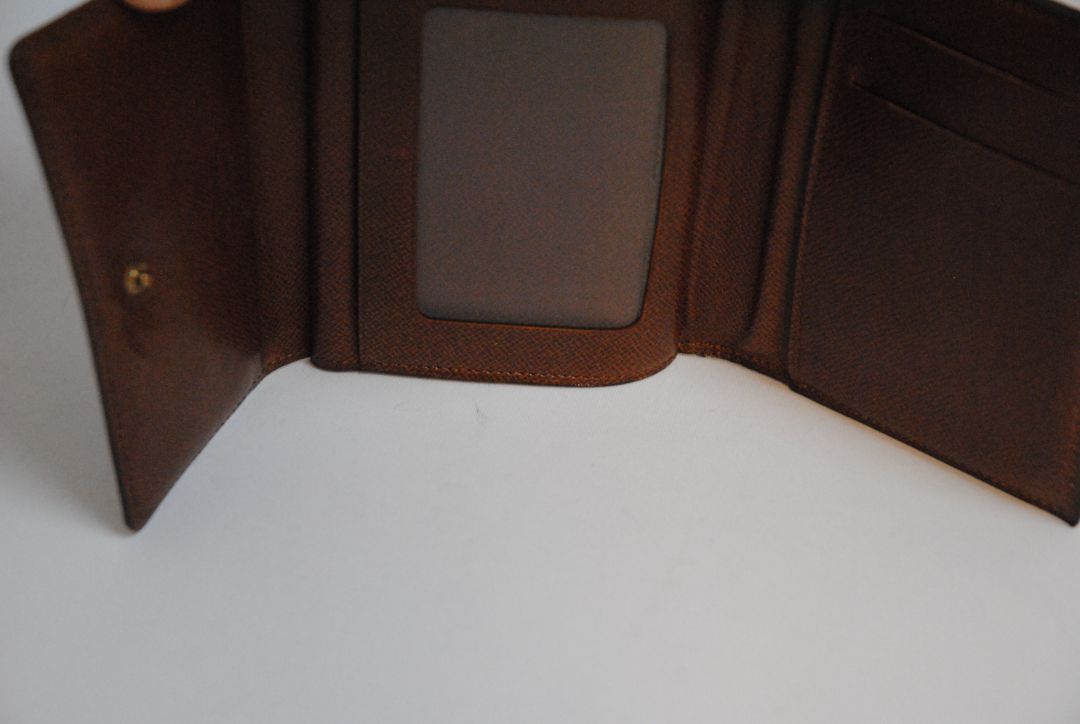 monogram Louis Vuitton canvas wallet, Approx. 4.3” W x 3.5” H x 1” D Compact bi-fold silhouette