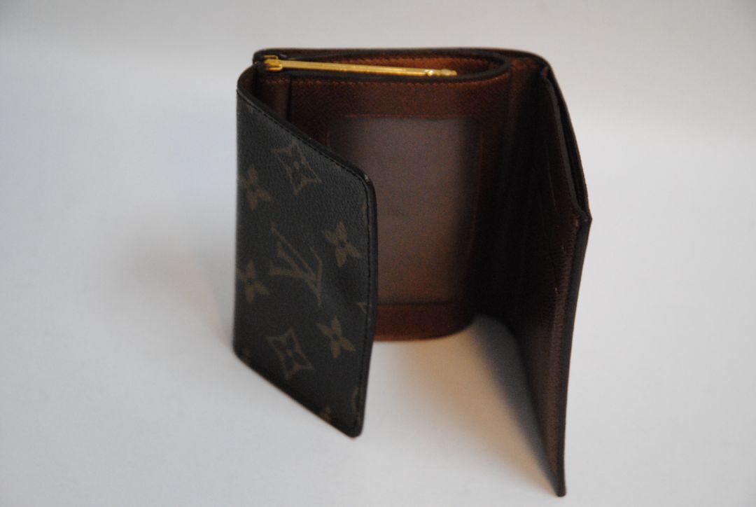 monogram Louis Vuitton canvas wallet, Approx. 4.3” W x 3.5” H x 1” D Compact bi-fold silhouette