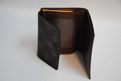 monogram Louis Vuitton canvas wallet, Approx. 4.3” W x 3.5” H x 1” D Compact bi-fold silhouette
