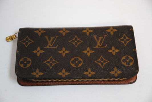 brown monogram Louis Vuitton Zippy Monogram Wallet, Approx. 7.7” W x 4.1” H x 1” D Long continental-style silhouette
