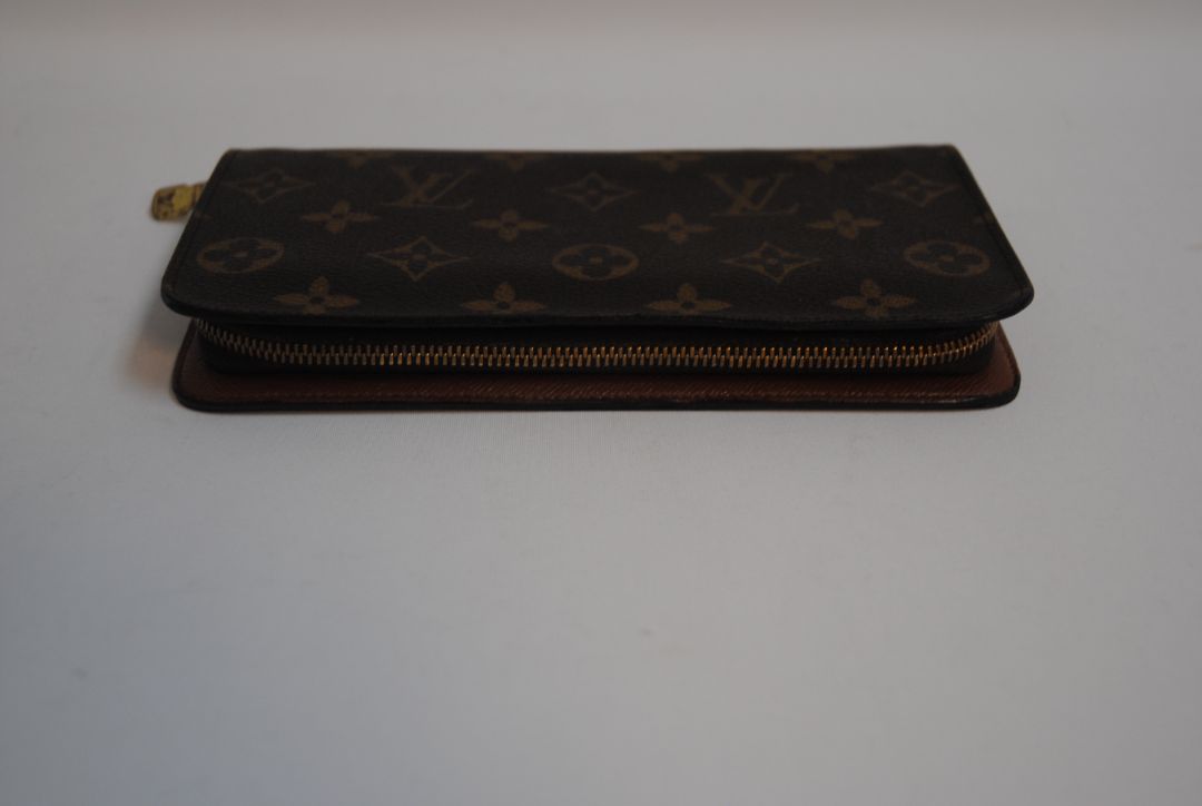 brown monogram Louis Vuitton Zippy Monogram Wallet, Approx. 7.7” W x 4.1” H x 1” D Long continental-style silhouette