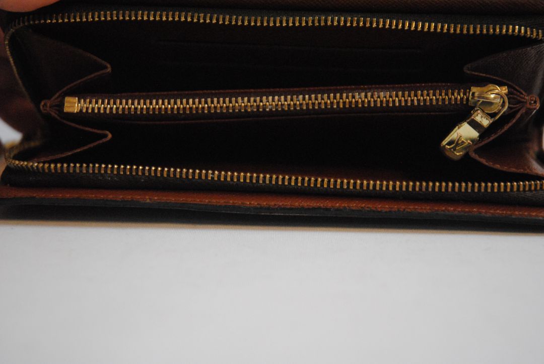 brown monogram Louis Vuitton Zippy Monogram Wallet, Approx. 7.7” W x 4.1” H x 1” D Long continental-style silhouette