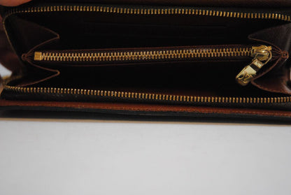 brown monogram Louis Vuitton Zippy Monogram Wallet, Approx. 7.7” W x 4.1” H x 1” D Long continental-style silhouette