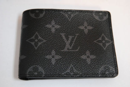 Exterior: Monogram Eclipse canvas (black with dark grey monogram pattern) Interior: Black leather Louis Vuitton Multiple Wallet in Monogram Eclipse Canvas, Length: 4.5 in (11.5 cm) Height: 3.5 in (9 cm) Depth: 0.6 in (1.5 cm)