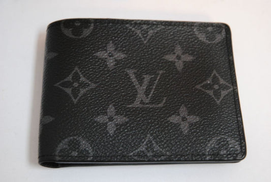 Exterior: Monogram Eclipse canvas (black with dark grey monogram pattern) Interior: Black leather Louis Vuitton Multiple Wallet in Monogram Eclipse Canvas, Length: 4.5 in (11.5 cm) Height: 3.5 in (9 cm) Depth: 0.6 in (1.5 cm)
