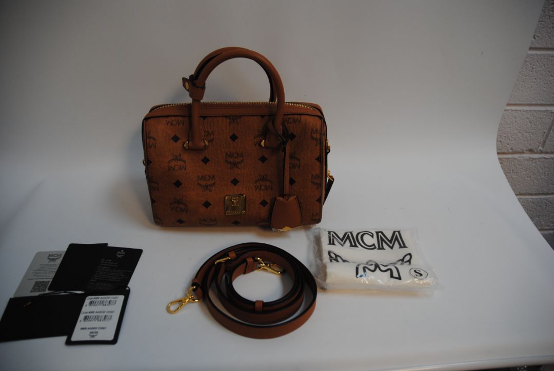 cognac MCM Essential Boston Bag – Medium, Length: 11.8 in (30 cm) Height: 7.5 in (19 cm) Depth: 6.7 in (17 cm) Handle Drop: 4 in (10 cm) Strap Drop: Adjustable up to 22 in (crossbody)