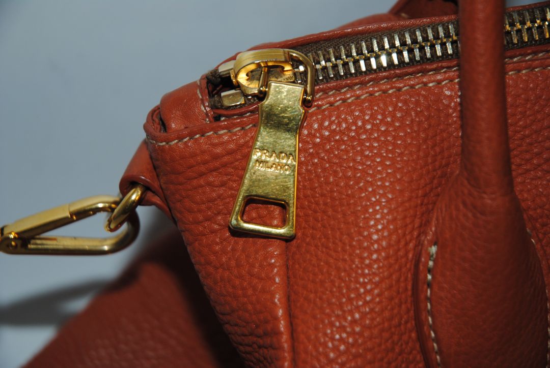 Burnt Orange / Papaya Prada Vitello Daino Zip Tote with Shoulder Strap, Length: 13.5 in (34 cm) Height: 10.5 in (27 cm) Depth: 6.5 in (17 cm) Handle Drop: 7.5 in (19 cm) Strap Drop: Up to 22 in adjustable