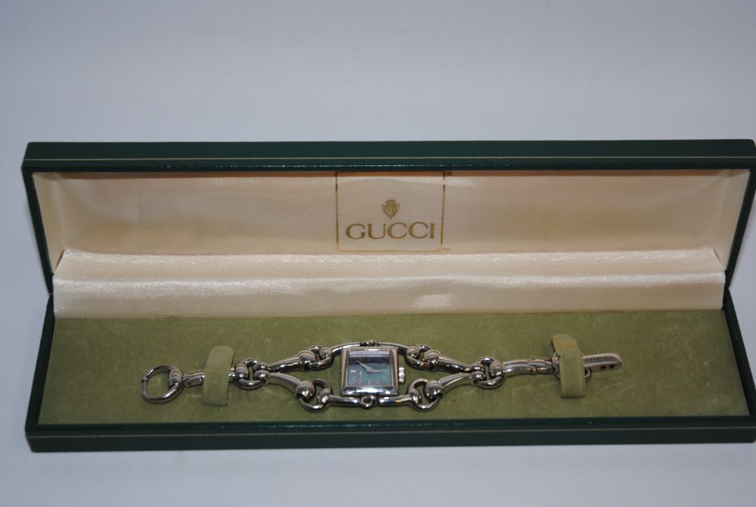 silver Gucci Gucci Horsebit Chain-Link Ladies Watch, Case Size: 20 mm (square) Bracelet Length: Fits wrists up to 6.5 in (16.5 cm) Bracelet Width: 10 mm