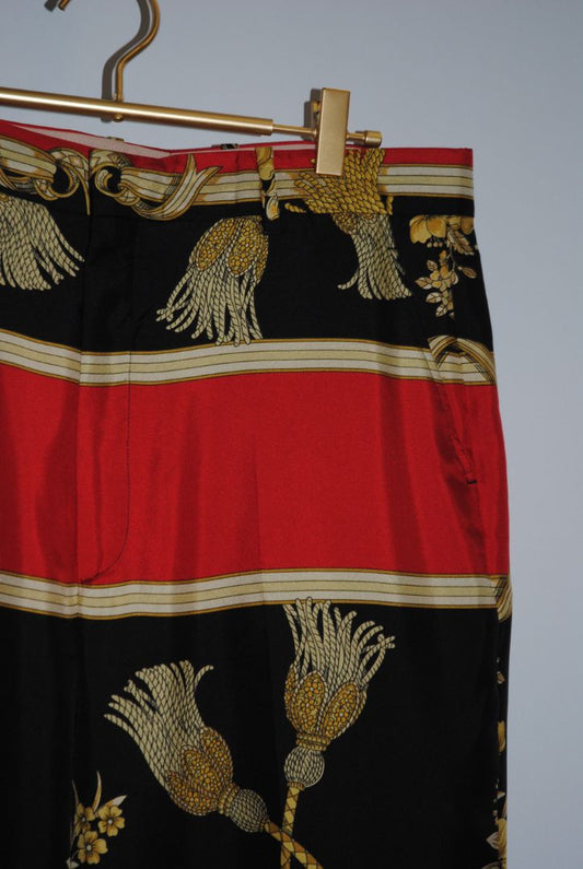 multi color Gucci Wide‑leg trousers with scarf‑print/baroque motif (gold/gilt scrolls/florals, rope/tassel detail), Waist approx. 30–34 in (depending on size) Inseam approx. 28–30 in (for a full-length wide leg) Leg‑opening width wide (perhaps 10–14 in ac