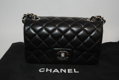 black lambskin Chanel classic flap bag, approx 25.5 cm (W) × 16 cm (H) × 7 cm (D) (≈ 10″ × 6.3″ × 2.75″) per size guide.