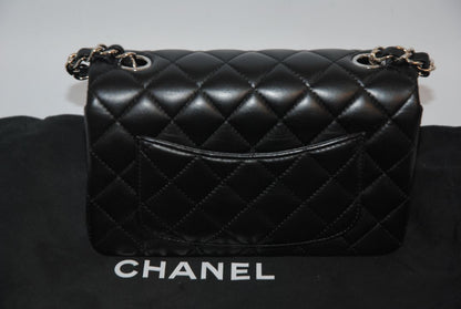 black lambskin Chanel classic flap bag, approx 25.5 cm (W) × 16 cm (H) × 7 cm (D) (≈ 10″ × 6.3″ × 2.75″) per size guide.