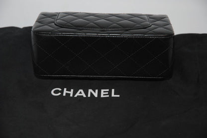black lambskin Chanel classic flap bag, approx 25.5 cm (W) × 16 cm (H) × 7 cm (D) (≈ 10″ × 6.3″ × 2.75″) per size guide.