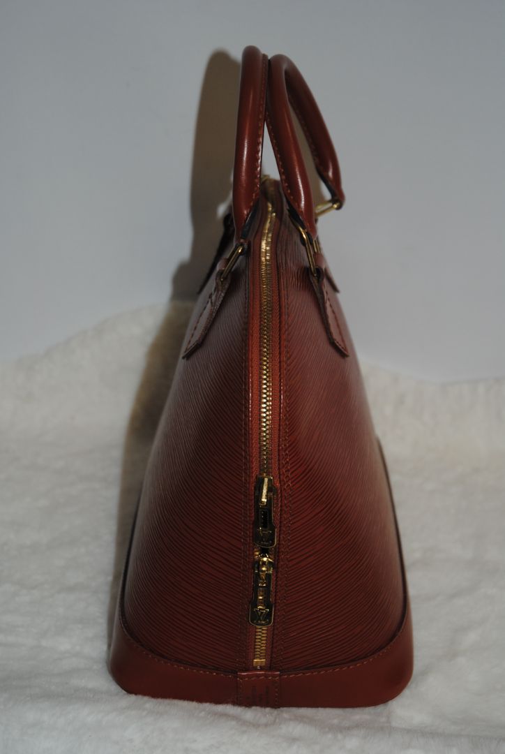 camel Louis Vuitton Epi Alma MM, Dimensions Length: 14.2 in (36 cm) Height: 10.6 in (27 cm) Depth: 6.7 in (17 cm)