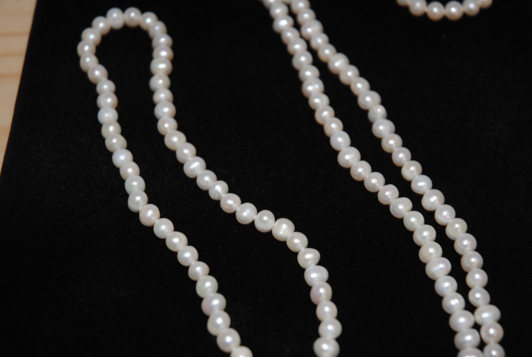 white NA opera necklace