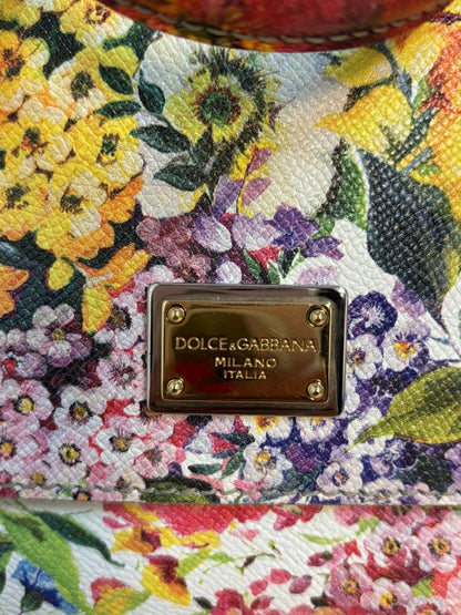 Close-up of Dolce & Gabbana logo plaque and floral print on Dauphine textured leather