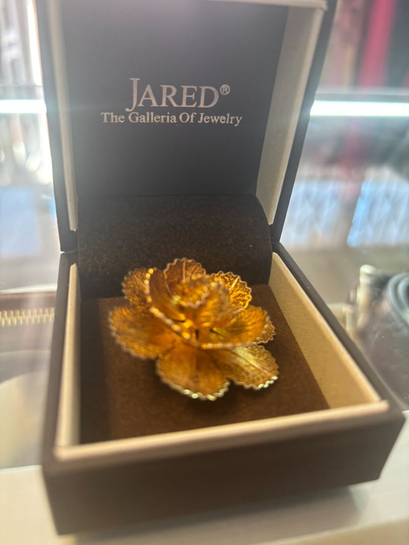 gold tone Jared brooch, Dimensions (Estimated from visual cues) • Diameter: ~2 inches (5.08 cm) • Height: ~1 inch (2.54 cm) • Weight: Unknown, but likely lightweight due to filigree structure