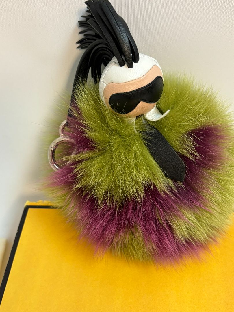 purple and green FENDI fur “monster” bag charm, pom-pom diameter: 10 cm (4 in) Total hanging drop (ring + strap + fur): ~20 cm (8 in)