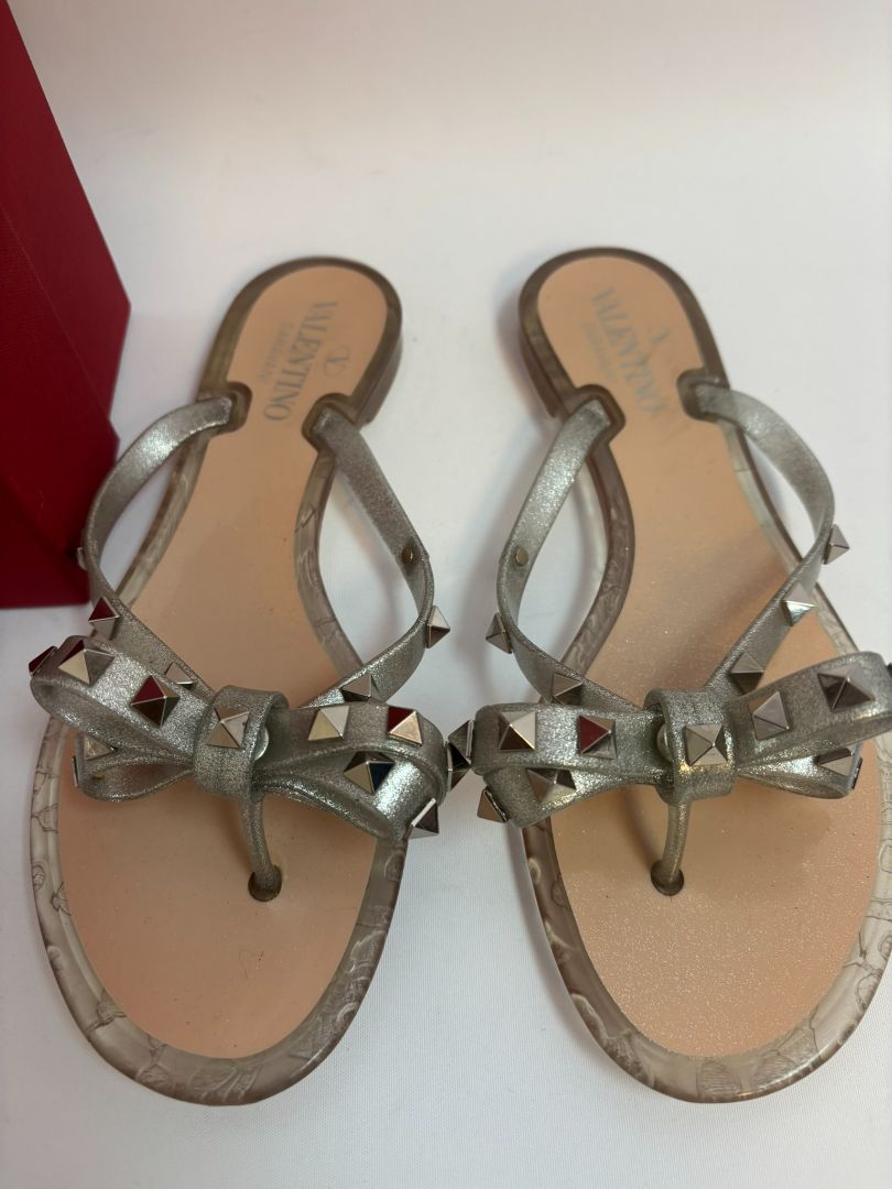 silver Valentino Garavani Rockstud Jelly Bow Thong Sandals, 37/ DIMENSIONS (Size EU 39 / US 9) Footbed Length: ~10.5 in Heel Height: Flat (~0.25 in molded heel)