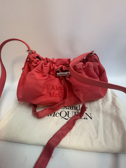 red Alexander McQueen drawstring bag, Length: 10 in Height: 6 in Depth: 3.5 in Strap Drop: Adjustable (approx. 12–20 in)
