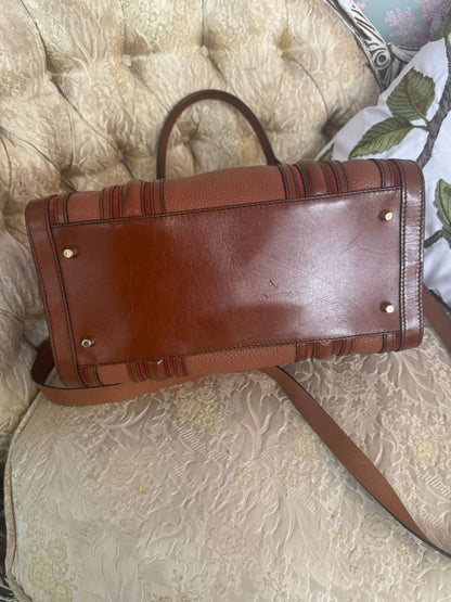 Cognac brown with multi-stripe accents in oxblood, black, and tan (subtle nod to Burberry’s house check palette) Burberry Model: Likely from the Banner or Orchard satchel line (structured silhouette with rolled handles and stripe accents), Length: 13 in (