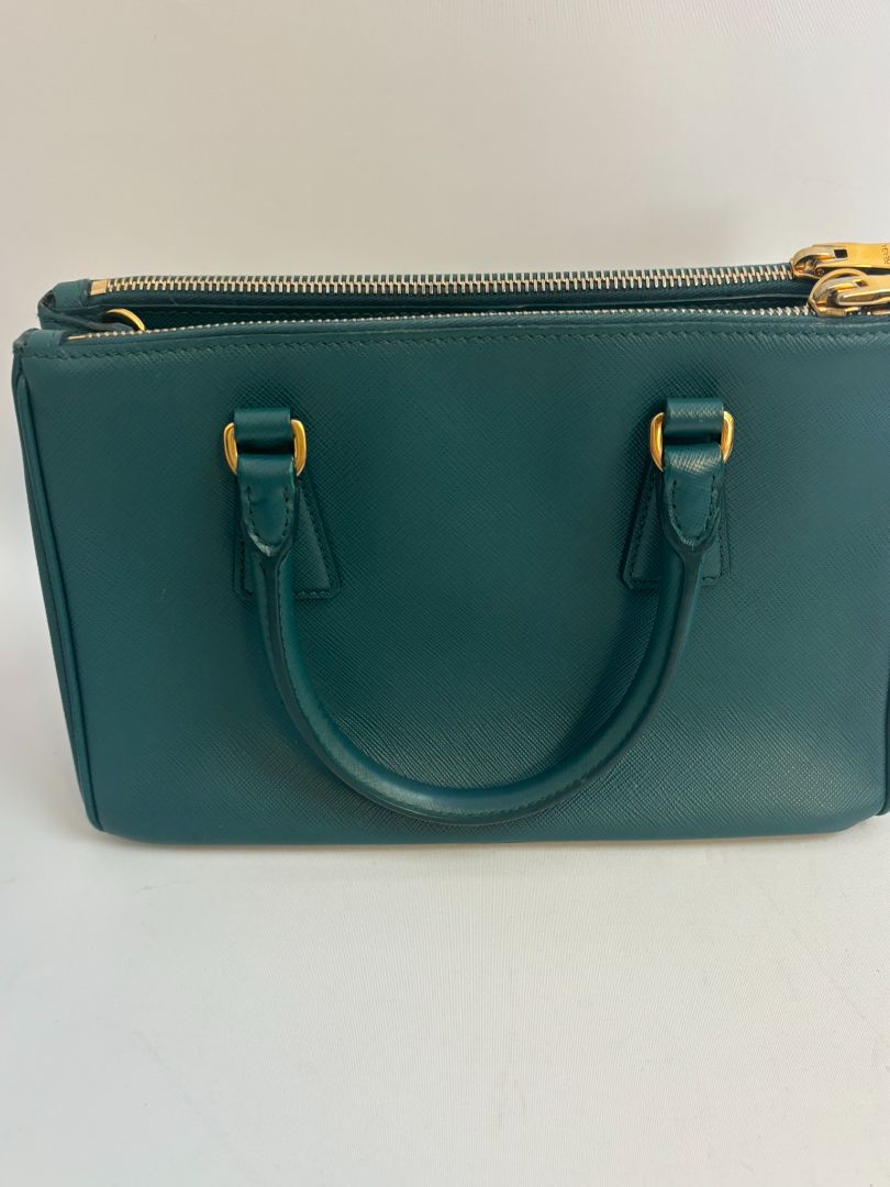 deep teal Prada Model: Double Zip Lux Tote (also known as Galleria Tote), Width: 11.5 inches (29 cm) Height: 8 inches (20 cm) Depth: 5 inches (13 cm) Handle Drop: 4 inches (10 cm) Strap Drop: 19–21 inches adjustable (48–53 cm)