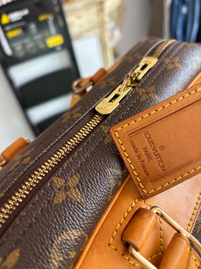 Close-up of LV monogram canvas, leather handles, and gold-tone zipper on Deauville bag