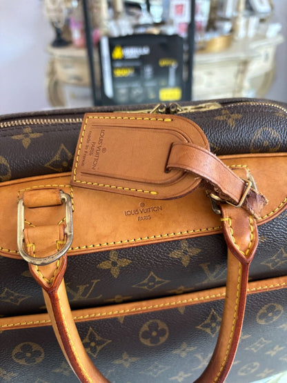 Close-up of LV monogram canvas, leather handles, and gold-tone zipper on Deauville bag