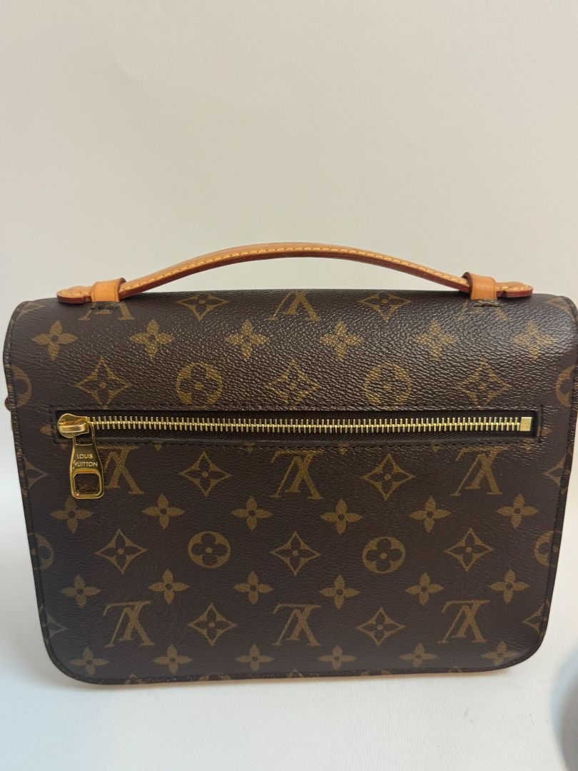 Louis Vuitton Pochette Métis in Monogram canvas, featuring the iconic LV logo print, a structured flap design, gold-tone hardware, and a detachable shoulder strap for versatile wear. This elegant crossbody bag is perfect for both day and night occasions.