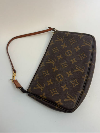 Louis Vuitton Pochette Monogram clutch bag with iconic brown monogram canvas and gold-tone hardware.