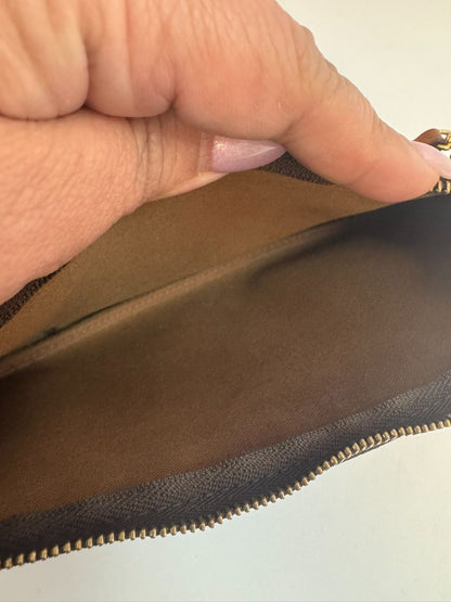 Louis Vuitton Pochette Monogram clutch bag with iconic brown monogram canvas and gold-tone hardware.