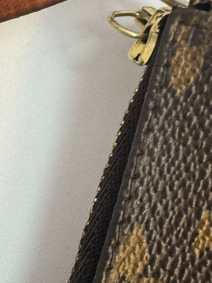 Louis Vuitton Pochette Monogram clutch bag with iconic brown monogram canvas and gold-tone hardware.