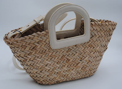Mini woven seagrass crossbody basket bag with a natural finish and adjustable strap.