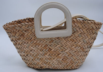 Mini woven seagrass crossbody basket bag with a natural finish and adjustable strap.