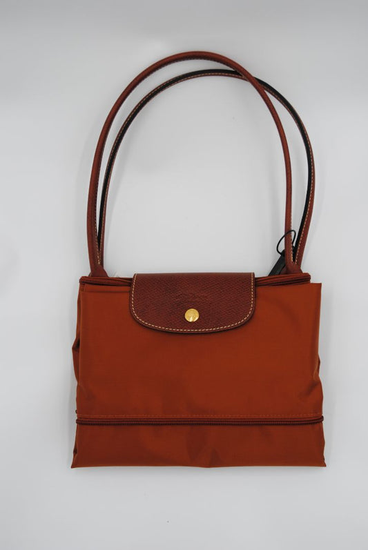 Front view of Longchamp Le Pliage expandable tote in large size with brown leather trim and gold-tone zipper