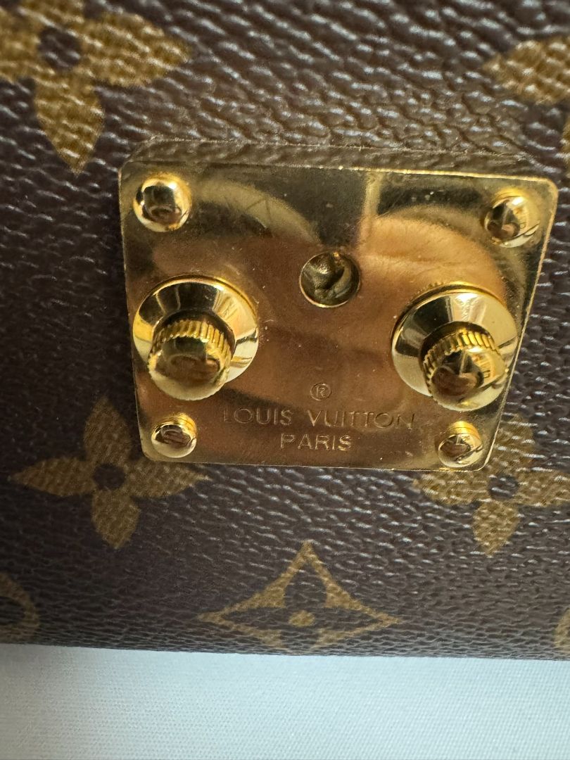 Louis Vuitton Pochette Métis in Monogram canvas, featuring the iconic LV logo print, a structured flap design, gold-tone hardware, and a detachable shoulder strap for versatile wear. This elegant crossbody bag is perfect for both day and night occasions.