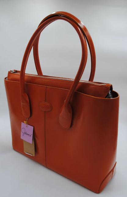 Side view of TOD'S D-Bag orange tote showing soft structured shape and pebbled Italian leather