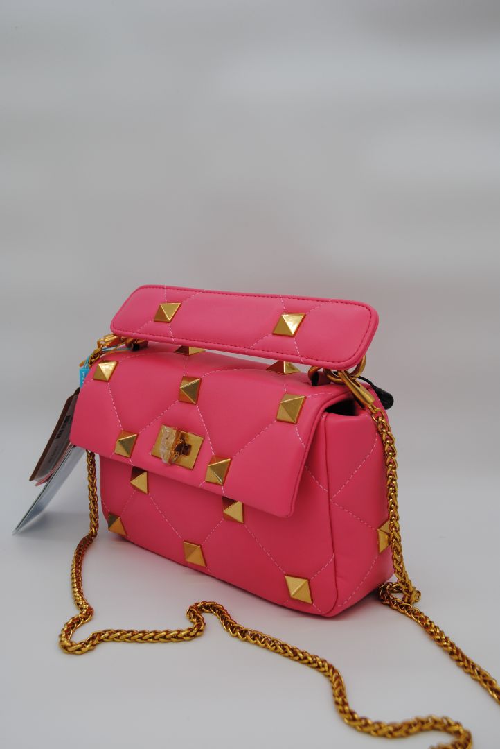 Side angle of Tiffany & Fred hot pink studded bag showing soft leather and structured shape
